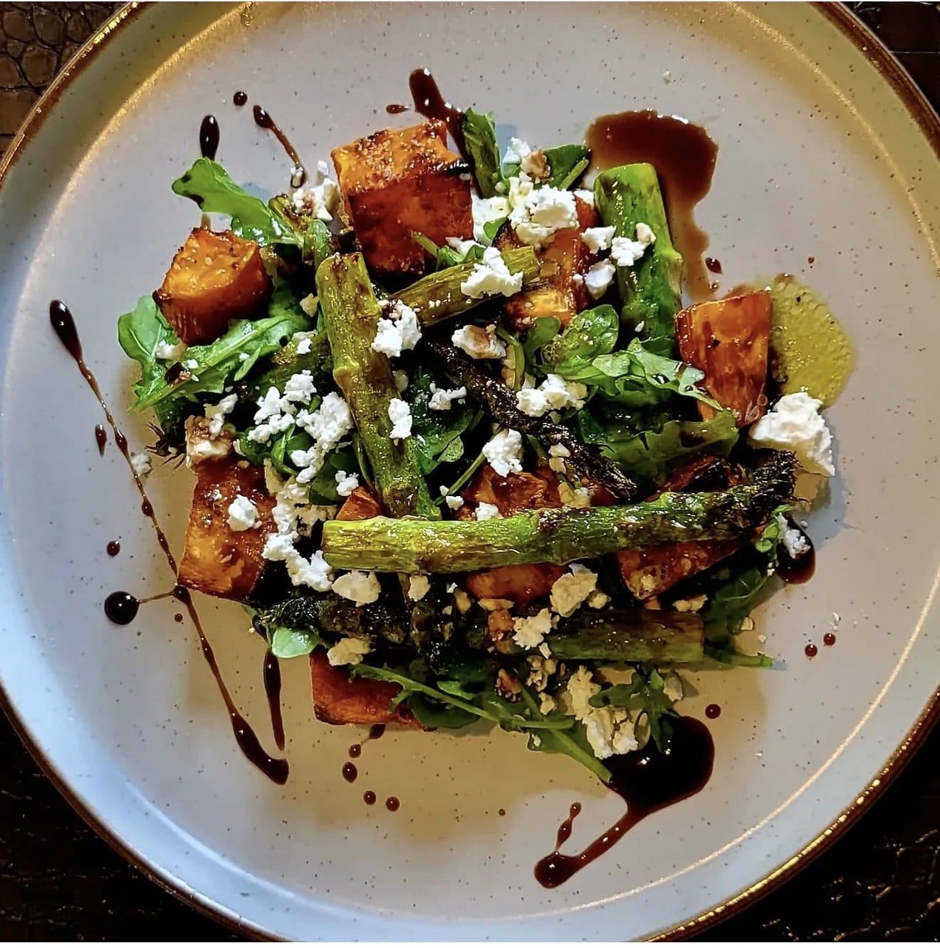 Roasted squash and charred asparagus with feta and rocket, dressed with balsamic