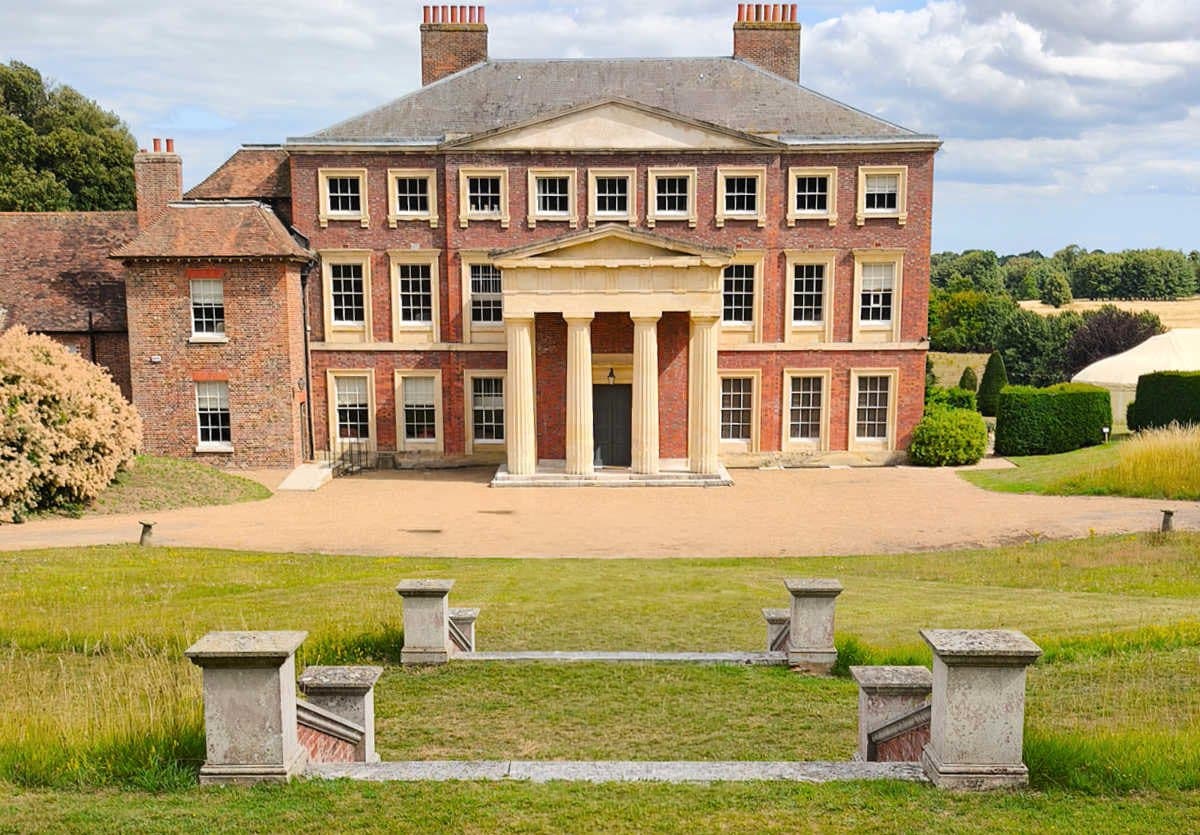 Goodnestone House: the red-brick façade and columned portico across the lawn on a summer day